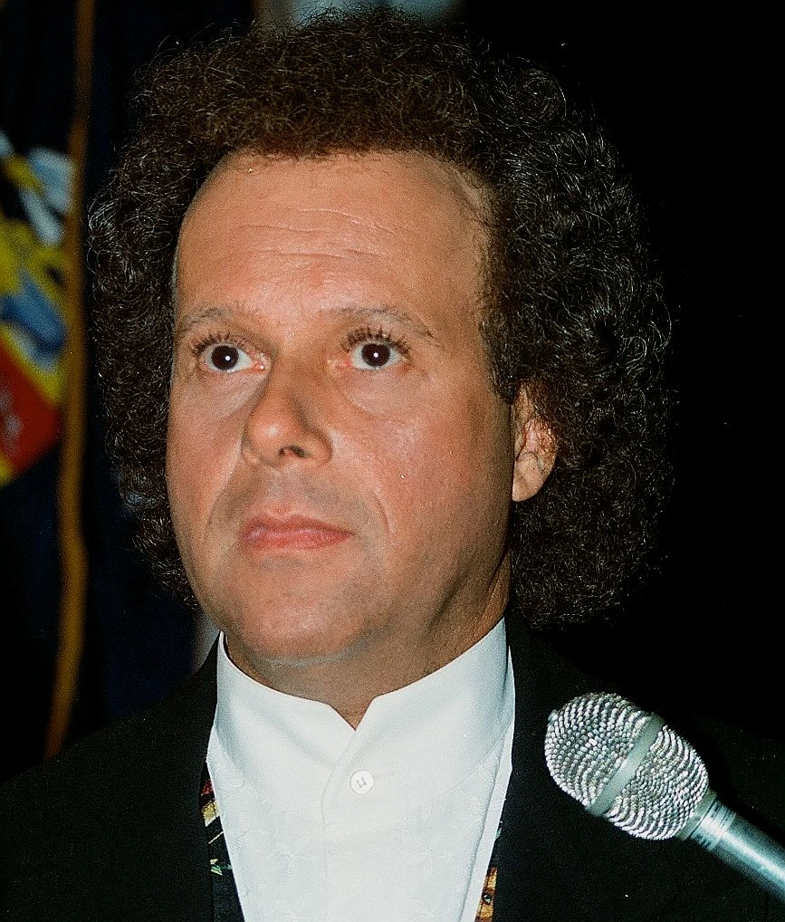 Richard Simmons portrait photo at a microphone