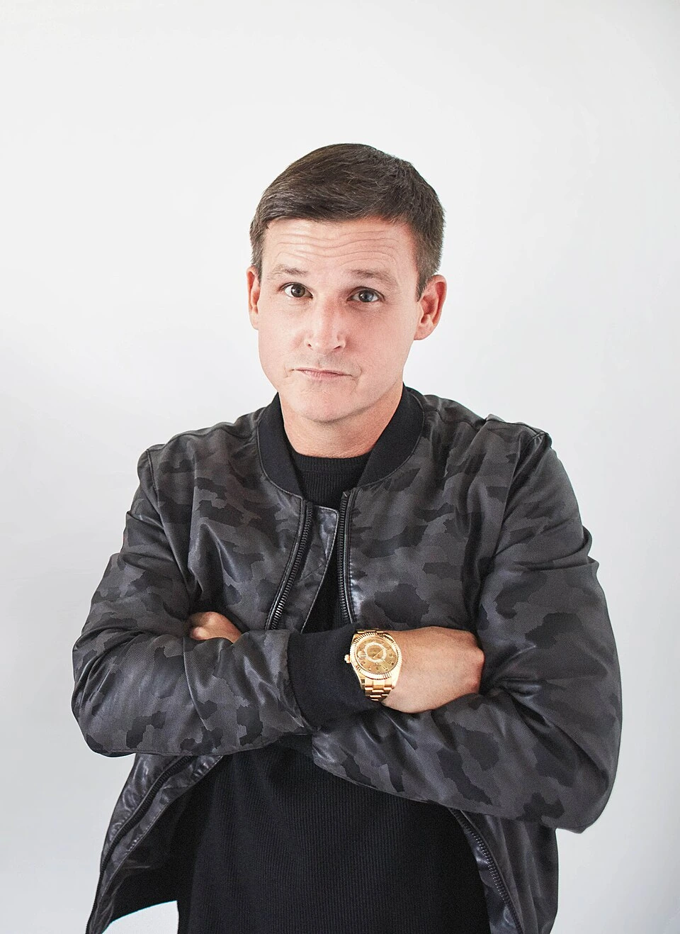 Portrait of Rob Dyrdek standing with arms crossed against a plain light background.